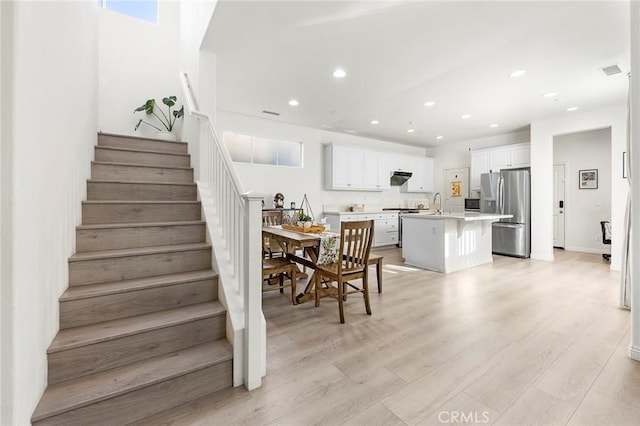 dining space with light wood-type flooring