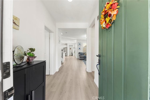 hall with light hardwood / wood-style flooring