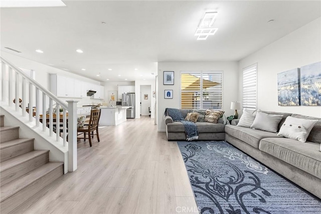 living room featuring light wood-type flooring and sink