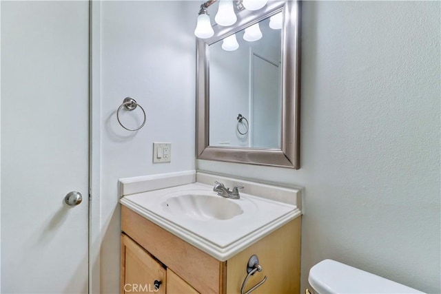 bathroom with vanity and toilet