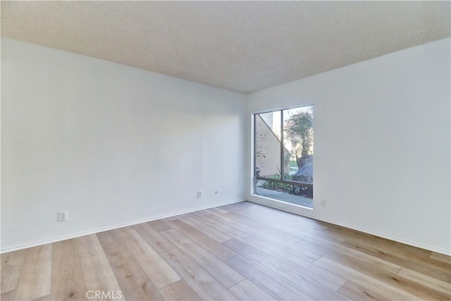 spare room featuring light wood-type flooring