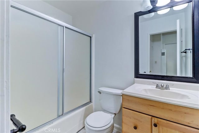 full bathroom with vanity, enclosed tub / shower combo, and toilet