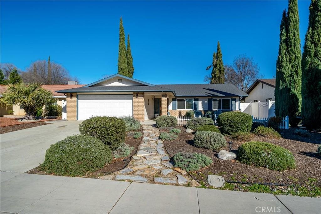 ranch-style house with covered porch and a garage