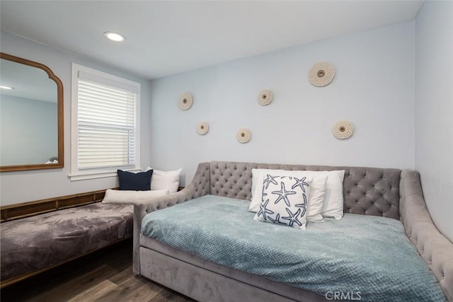 bedroom with dark hardwood / wood-style flooring