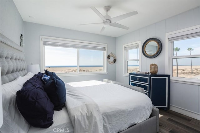 bedroom with multiple windows, dark hardwood / wood-style floors, and ceiling fan