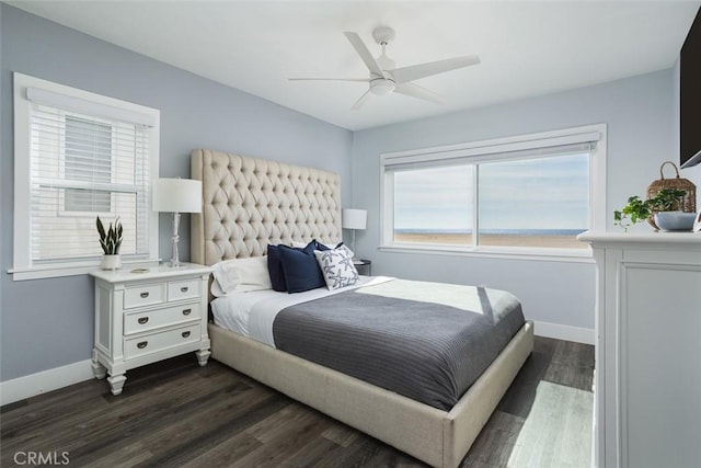 bedroom with dark hardwood / wood-style flooring and ceiling fan