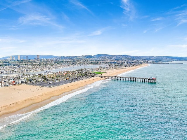 birds eye view of property featuring a view of the beach and a water and mountain view