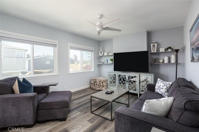 living room featuring hardwood / wood-style floors and ceiling fan