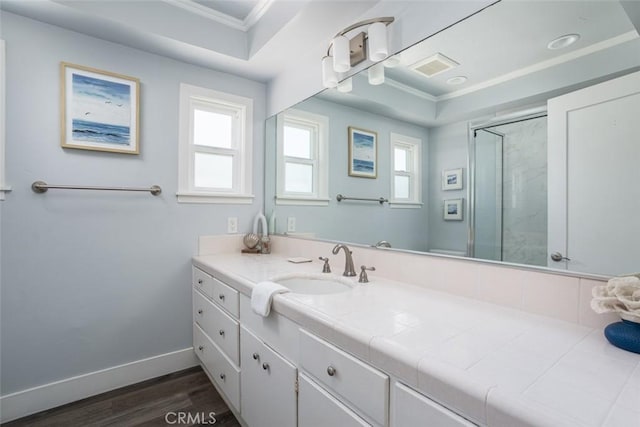 bathroom with crown molding, vanity, wood-type flooring, and an enclosed shower