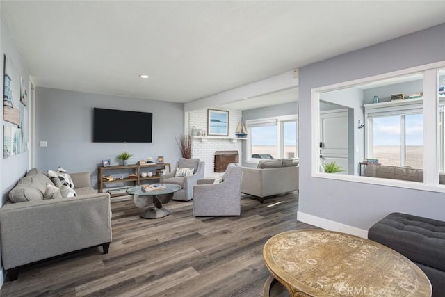 living room with dark hardwood / wood-style flooring and a healthy amount of sunlight