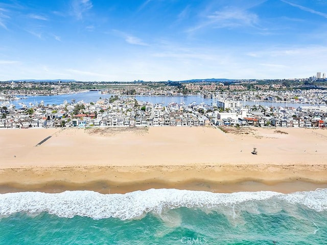 birds eye view of property with a water view and a view of the beach