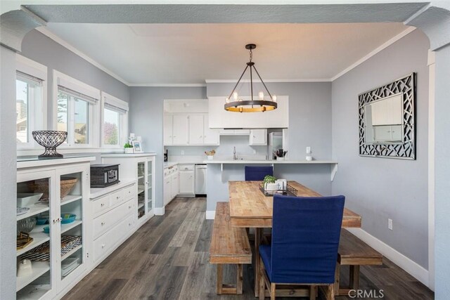 dining space featuring wine cooler, sink, dark hardwood / wood-style floors, and ornamental molding