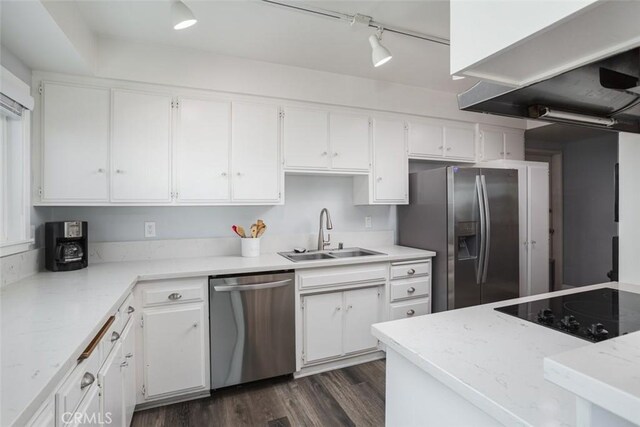 kitchen with white cabinetry, sink, dark wood-type flooring, exhaust hood, and appliances with stainless steel finishes