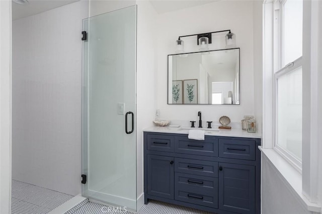 bathroom with vanity and a shower with door