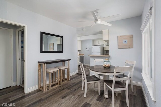 dining space featuring ceiling fan and dark wood-type flooring