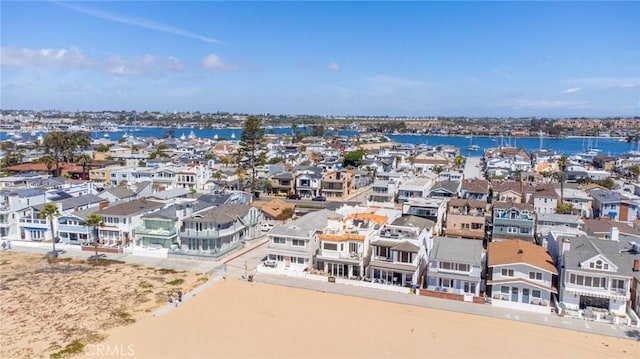 birds eye view of property featuring a beach view and a water view