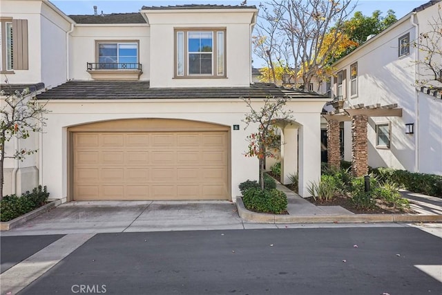 mediterranean / spanish-style home with a garage