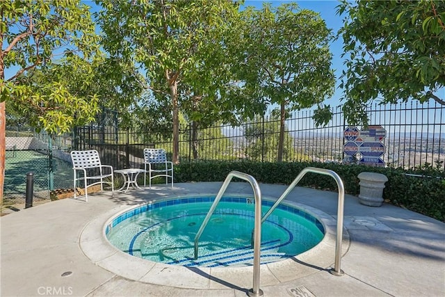 view of pool featuring a patio area and a community hot tub