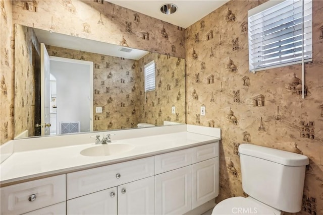 bathroom featuring vanity and toilet