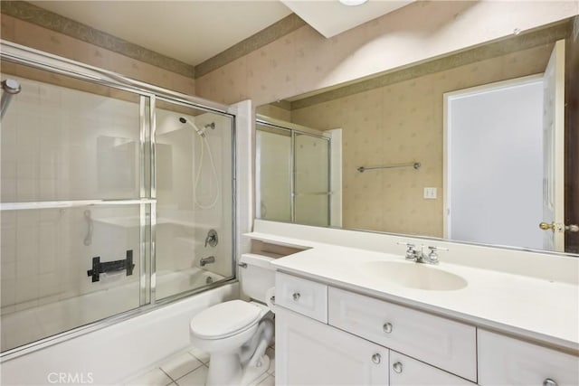 full bathroom with shower / bath combination with glass door, tile patterned floors, vanity, and toilet