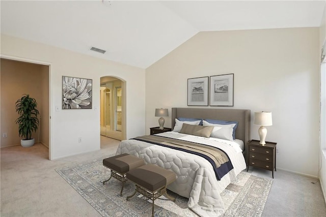 carpeted bedroom with lofted ceiling