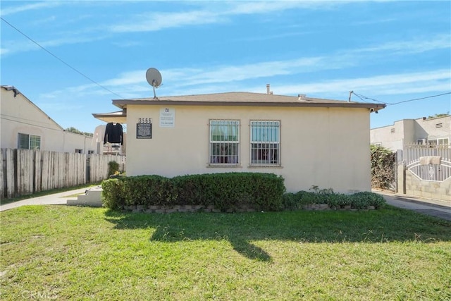 view of side of home featuring a lawn