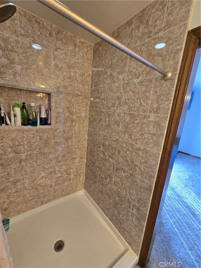 bathroom with tiled shower