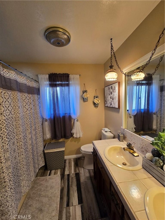 bathroom featuring hardwood / wood-style floors, vanity, and toilet