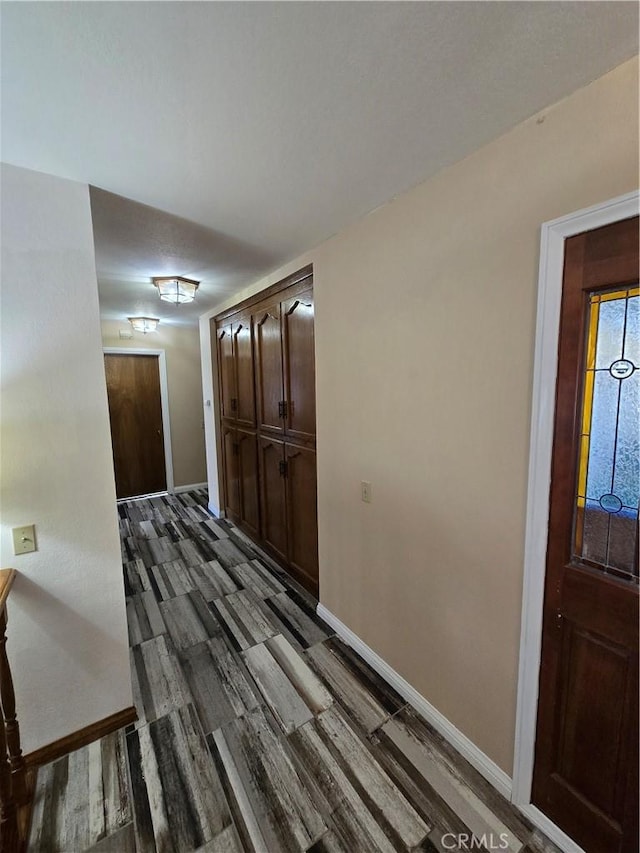 hallway with dark wood-type flooring