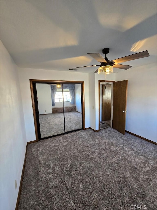 unfurnished bedroom with ceiling fan, a closet, and carpet floors