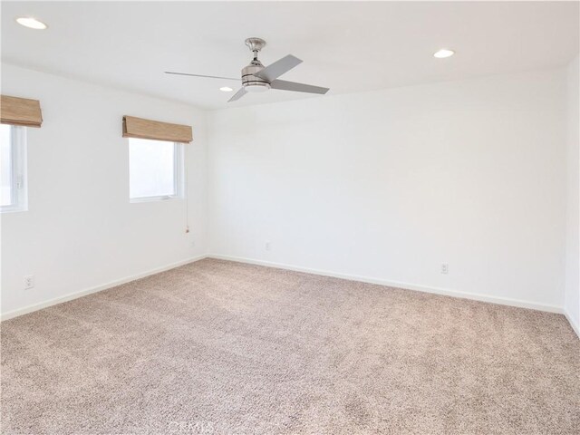 carpeted empty room featuring ceiling fan