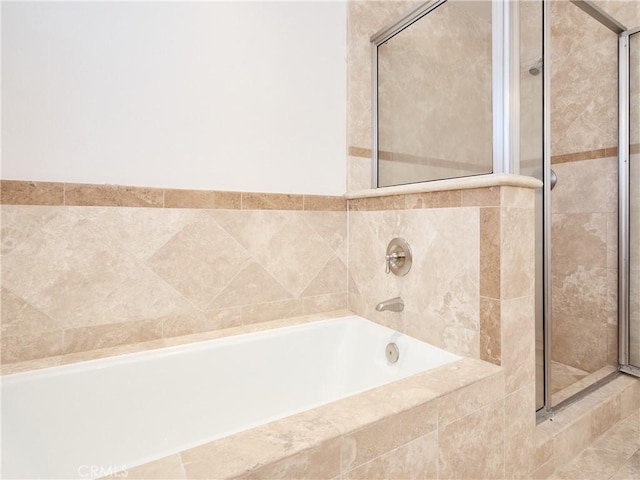 bathroom featuring shower with separate bathtub