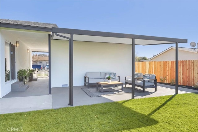 rear view of house with a yard, an outdoor living space, and a patio area