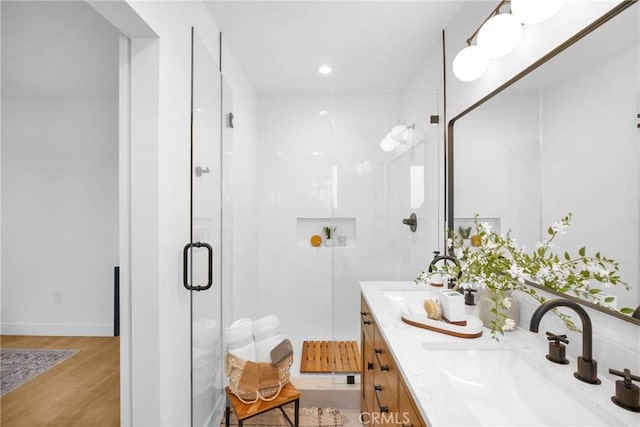 bathroom featuring vanity, a shower with shower door, and hardwood / wood-style flooring