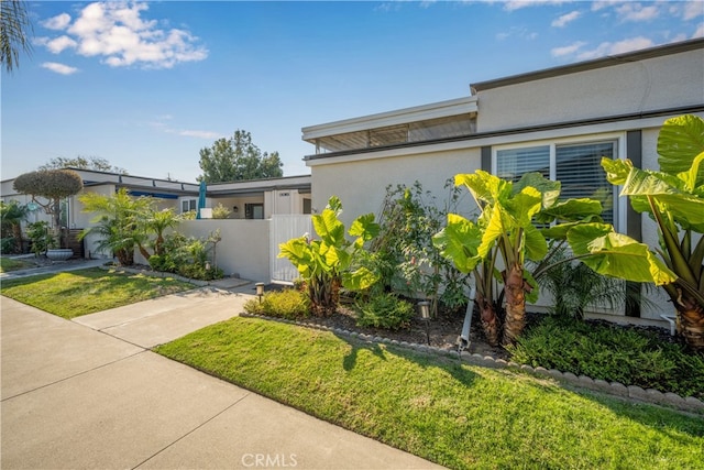 view of property exterior with a yard