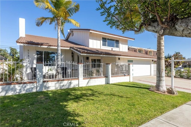 view of front of house with a garage and a front lawn