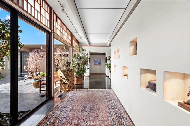 hallway featuring a high ceiling