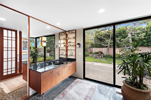 entryway with a wall of windows and sink