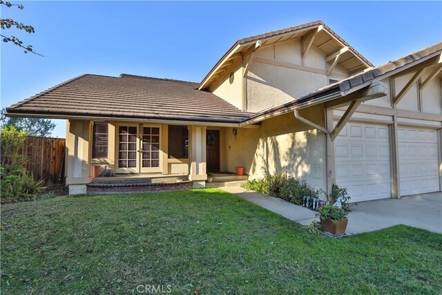 view of front of home with a front lawn and a garage