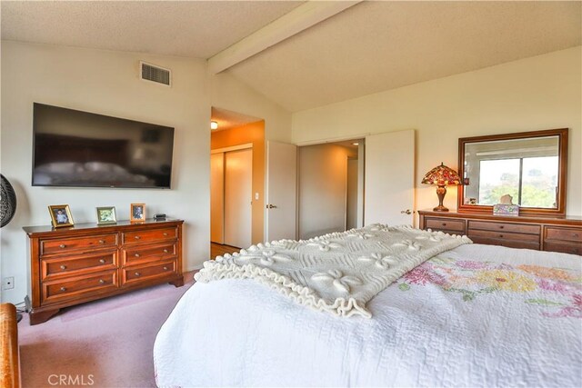 bedroom featuring carpet, a closet, and vaulted ceiling with beams