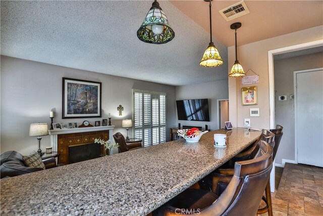 kitchen featuring a textured ceiling and a kitchen breakfast bar