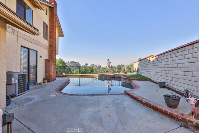 view of swimming pool featuring an in ground hot tub, central AC unit, and a patio