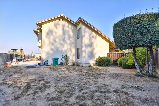 rear view of property featuring a patio