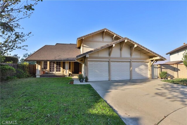 view of front of property featuring a front lawn and a garage