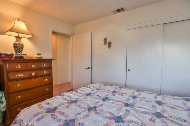 bedroom featuring a closet and a textured ceiling