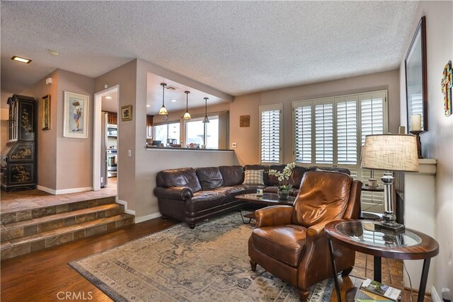 living room featuring a textured ceiling and hardwood / wood-style floors