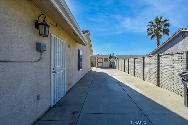 view of patio featuring a storage unit