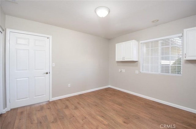 spare room featuring light hardwood / wood-style floors