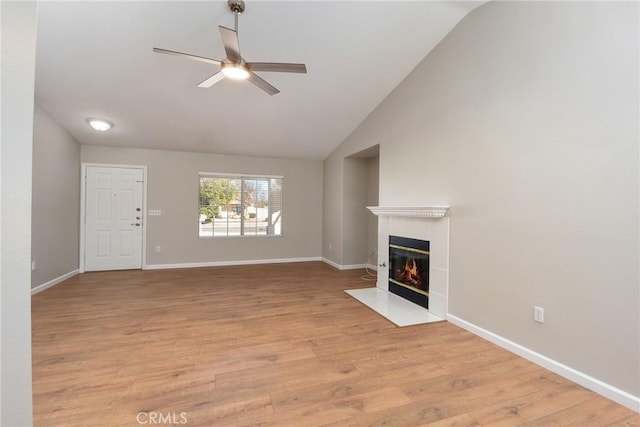 unfurnished living room with light hardwood / wood-style floors, ceiling fan, and lofted ceiling