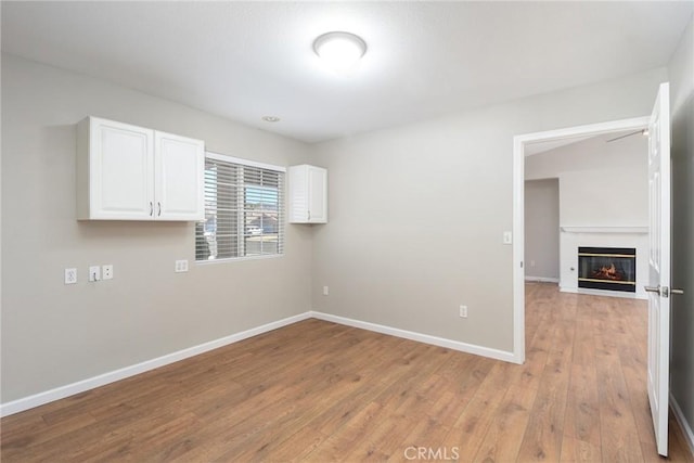 spare room with light wood-type flooring